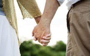 an older couple holding hands. by Rawpixelimages Dreamstime. 45 years after a teen infatuation and both are single again. Can a romantic reconnection work for them? See what “Ask Amy” advises. Image