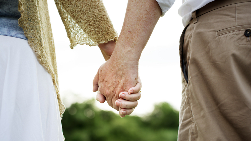 an older couple holding hands. by Rawpixelimages Dreamstime. 45 years after a teen infatuation and both are single again. Can a romantic reconnection work for them? See what “Ask Amy” advises. Image