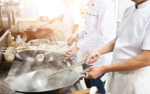 Chefs working in a Chinese restaurant kitchen. Photo by Sarayuth Punnasuriyaporn, Dreamstime. Chicago, 1957, two boys found fun in watching food prep at a Chinese restaurant. Their experience led to positive influences throughout life. Image