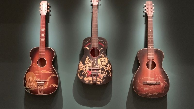 three cowboy guitars on display at the VMFA exhibition, 