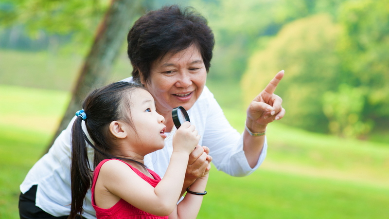 grandmother and granddaughter together looking closely outside something outside. Image by Szefei, Dreamstime. Mom plays favorites, so Grandmom plays favorites with the disfavored granddaughter. Do two rights make a wrong? See what “Ask Amy” says.