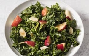 If you’re getting ready for the holidays or just hankering for a tasty way to eat healthy, this slightly sweet kale salad satisfies. Image