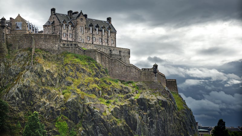 Edinburgh castle on a dreary, overcast day. With a colorful and sometimes grimy history, Edinburgh, Scotland, offers a rich look at the passage of Scottish time. Travel writer Rick Steves guides readers through the historic castle and capital city, with tips on must-sees and must-dos on a visit.