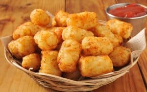 A basket of tater tots with a container of ketchup. Image by Msphotographic. Image