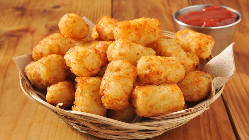 A basket of tater tots with a container of ketchup. Image by Msphotographic.