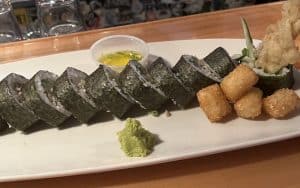 Sticky Rice sushi and Tater Tots together on a platter Image