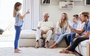 An extended family playing charades. Image by Monkey Business Images. Resurrect some of your old childhood games to bond with your grandchildren, support important skills, and create lasting memories. Image
