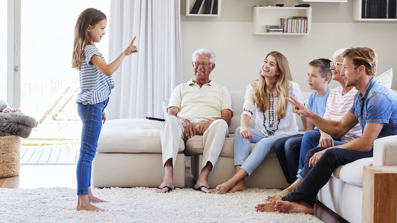 An extended family playing charades. Image by Monkey Business Images. Resurrect some of your old childhood games to bond with your grandchildren, support important skills, and create lasting memories. Image