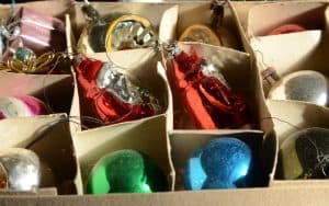 a box of old Christmas decorations. image by Kim Christensen. Some mementoes retain a rich meaning for years. For Boomer reader Julia Nunnally Duncan, her mother’s Christmas decorations have become more valuable with age. Image