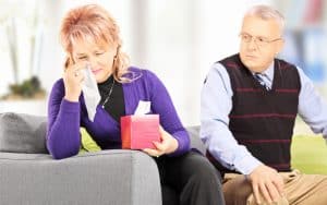 Woman wiping his eyes from crying after quarrel with her husband at home. Photo by Ljupco. For Ask Amy article on a husband's family who ignores his new wife Image