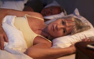 worried wife in bed, for article on a lying cheating husband. Image by Monkey Business Images Image