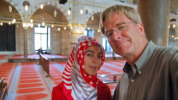 Rick Steves takes a selfie with a Muslim woman.
