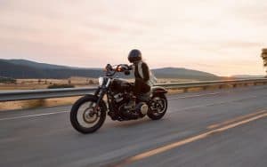 woman riding a Harley Davidson on the open road. For you boomers who were born to be wild, we offer 7 of the best motorcycle road trips for baby boomers, from all over our great country. Image