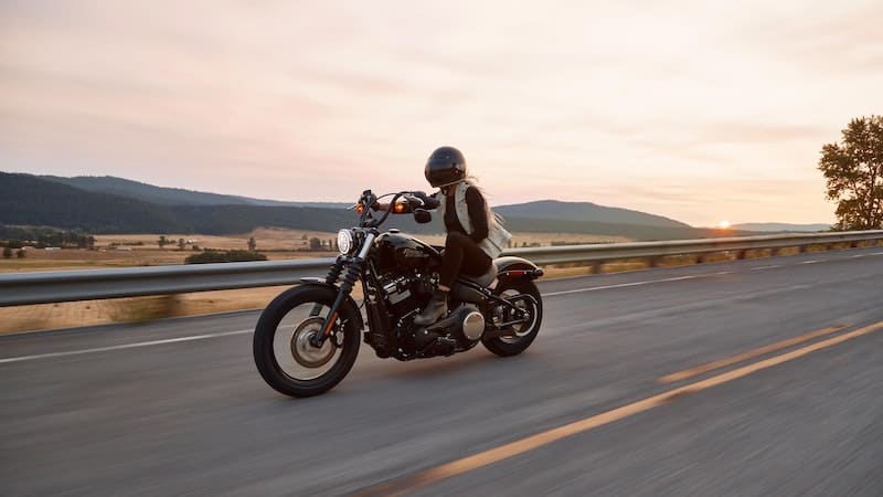 woman riding a Harley Davidson on the open road. For you boomers who were born to be wild, we offer 7 of the best motorcycle road trips for baby boomers, from all over our great country.