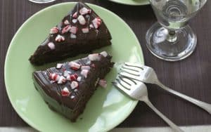 Moist, dense Chocolate Peppermint Cake is studded with chocolate-covered peppermint patties. Crushed peppermint candy adds crunch and a festive touch to the topping. Image