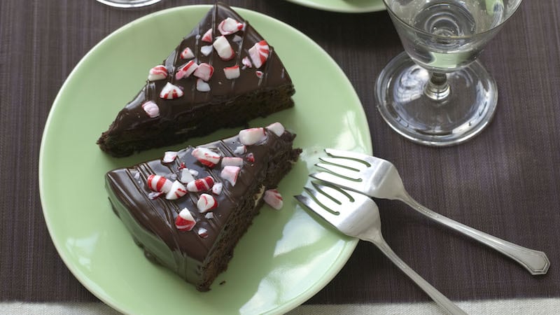 Moist, dense Chocolate Peppermint Cake is studded with chocolate-covered peppermint patties. Crushed peppermint candy adds crunch and a festive touch to the topping. Image
