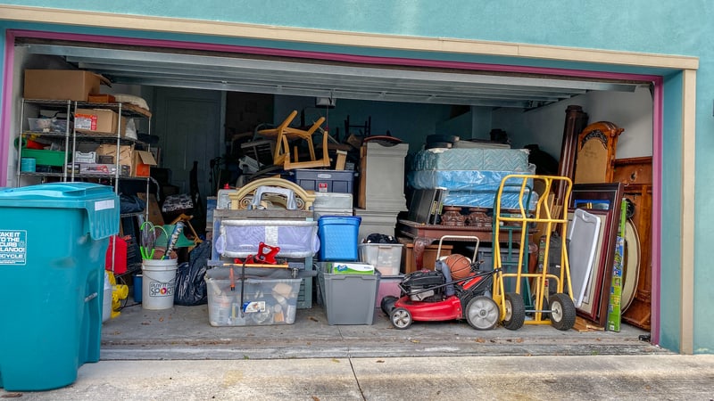 an overcrowded garage full of stuff. Image by Joni Hanebutt. "Is my husband a hoarder?" a wife wonder. He collects more and tosses nothing – and she’s had it. See what Ask Amy advises.