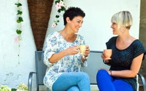 two women chatting, outside, seated, with coffee. Image by Dean Bertoncelj. These 5 gratifying resolutions are easy and enjoyable, yet they can improve us from the inside out so we can achieve the external goals. Image