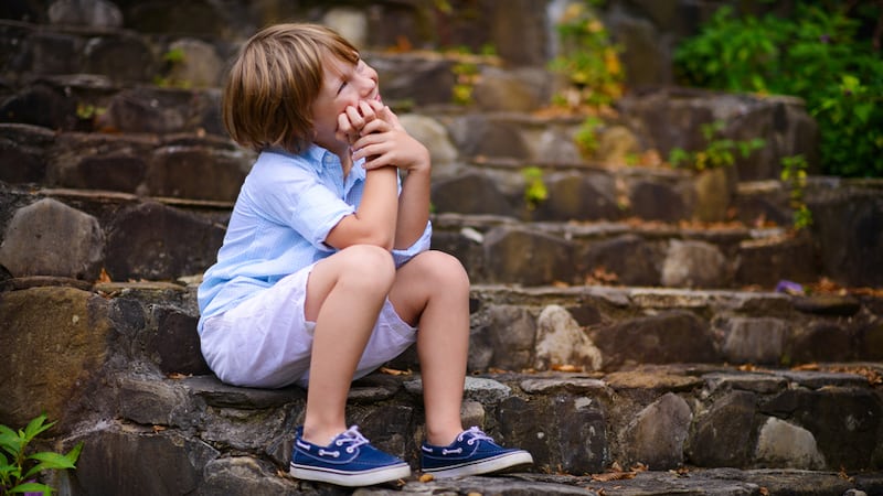 young boy sitting on stone steps. by Tatiana Bobkova. As Boomer reader R.G. Begora recalls his childhood, he recalls several tales that make him seem like a bad boy … or a dumb kid. Perhaps you can relate! Image