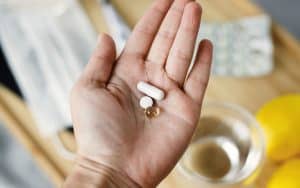 Hand holding pills. Over-the-counter zinc supplements could be one way to make cold and flu season a bit easier. What can we do to prevent and treat seasonal illnesses? We look at zinc for colds and flu and Covid. Does it really work? Image