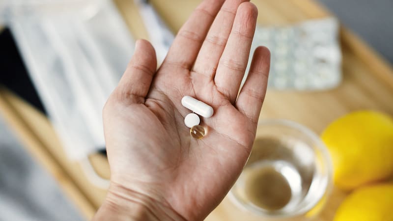 Hand holding pills. Over-the-counter zinc supplements could be one way to make cold and flu season a bit easier. What can we do to prevent and treat seasonal illnesses? We look at zinc for colds and flu and Covid. Does it really work?