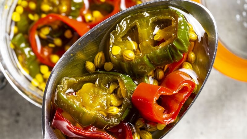 Making candied jalapeños is as easy as heating sliced fresh chiles in a seasoned simple syrup and letting them cool for a versatile topping. The balance of flavors and texture add versatility to these magnificent morsels. Image