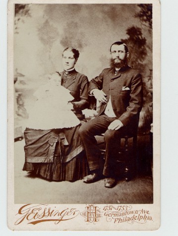 Old photo, Margaret Jane and John Kerr, with a baby in Margaret Jane's lap.