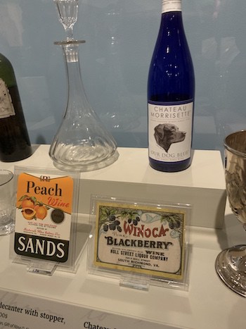 Decanter, wine from 1950s wineries in Central Virginia, and a Chateau Morissette wine bottle. Part of the "Cheers, Virginia" exhibition 