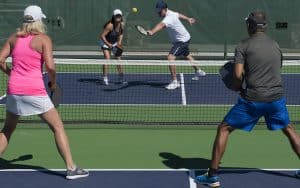 Four people playing pickleball. By Robert Hills. Our senior sport has been commandeered by a younger crowd. Humorist Greg Schwem shares how he feels about the pickleball court takeover. Image