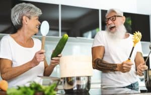 man and woman in kitchen laughing, by Alessandro Biascioli. Comfortable Home Remodeling Tips for Aging-in-Place Image