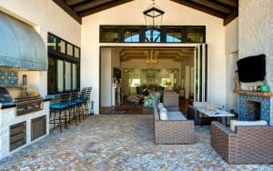 Outdoor seating area, grill, and bar at large house. by Danny Raustadt. Tips for choosing the right outdoor bar furniture: with so many options, here's how to choose pieces that work for your style and space. Image