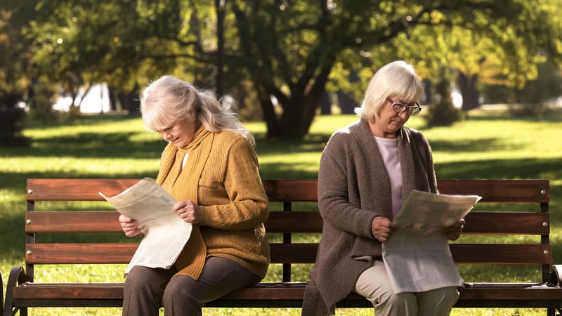 Two women on a park bench, both reading a newspaper, with their backs turned to each other. By motortion. A long-time friend has become so bossy about offering unsolicited advice that her friend has been avoiding her. See what advice columnist Amy Dickinson advises in this edition of Ask Amy.