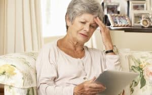 woman doing puzzle on tablet. Photo from monkey business images. Boggle Puzzle: Find the Hidden Countries Image