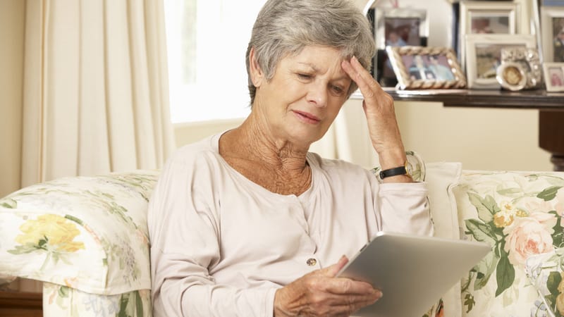 woman doing puzzle on tablet. Photo from monkey business images. Boggle Puzzle: Find the Hidden Countries