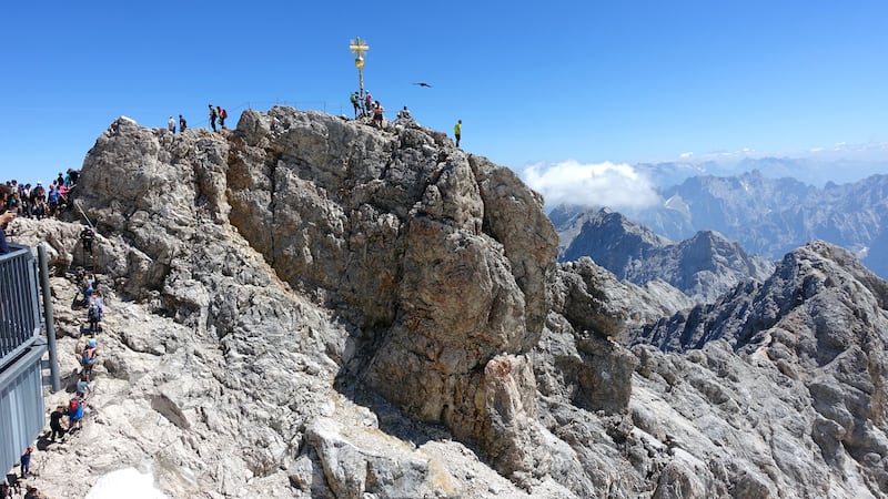 A golden cross marks the top of the 9,700-foot Zugspitze, the highest point in Germany. The mountain straddles the border between Germany and Austria, and lifts from both countries whisk visitors to the top. Travel writer Rick Steves transports us to the Zugspitze in Germany – it's worth a visit!