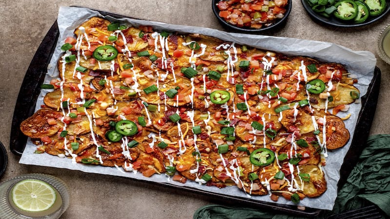 The heartiest hybrids on the pub scene, Irish Nachos, were invented in 1980 at J. Gilligan’s Bar and Grill in Arlington, Texas. Thin-sliced potatoes are roasted until crisp then topped with all your favorite nacho toppings in this comfort food twist.