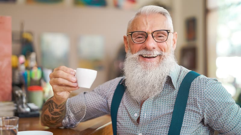 smiling middle-aged hipster man at a bar. By Alessandro Biascioli. Humorist Greg Schwem bemoans the dying art of face-to-face communication, a modern-day social “pandemic,” worsened by smartphone usage. Image