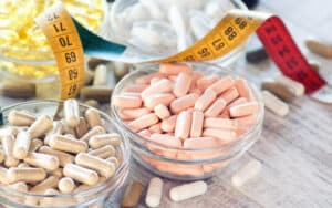 dietary supplements and a tape measure. Will taking a probiotic supplement help you lose weight? Mayo Clinic weighs in on the probiotics and weight loss connection – and if there is one. Image
