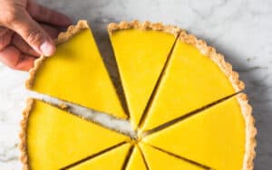 The bright citrusy taste and vibrant yellow color make the Lemon Olive Oil Tart perfect for a warm weather splurge! Image