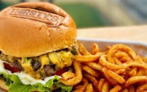 A burger with curly fries from Thirsty's at Massanutten, for article on finding fun and food in Massanutten Image