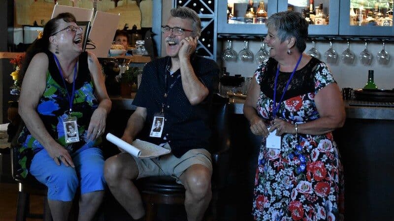 Three 60-something people laughing at their high school reunion. Does a high school reunion lose its appeal 50 years after graduation? Ed Grifone thought so, but he pitched in to help organize one anyway. Image