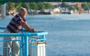 Man fishing from a dock. Image by Paul Prescott. make even your first-time fishing trip a success Image