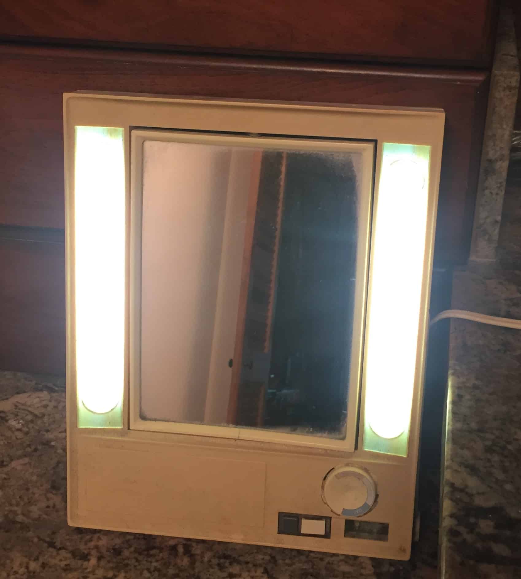 An old lighted make-up mirror, for essay on the face in the mirror.
