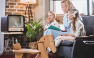 1950s family re-creation, mother and two children in a living room. From Lightfieldstudiosprod. For article on 