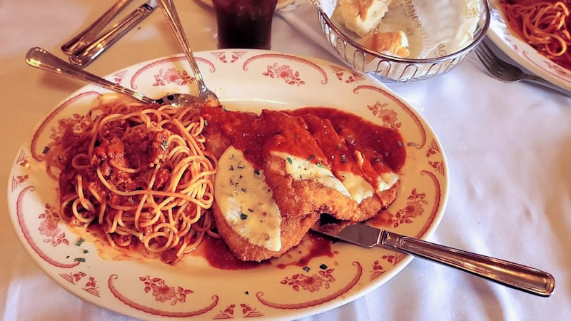 Maggiano's family style dining - plate of spaghetti with meat sauce, and cutlets with parmesan