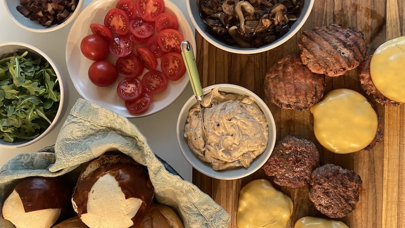 A burger buffet of burgers, tomatoes, toppings, buns, etc. This burger bar proves flexible when guest count fluctuates.