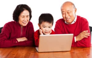 grandparents and grandkid looking at a laptop together, from Suprijono Sujarjoto. Two Jumble puzzles challenge you to pop the secrets. Play one with a favorite kid or use as a warm-up, then tackle the harder puzzle. Image
