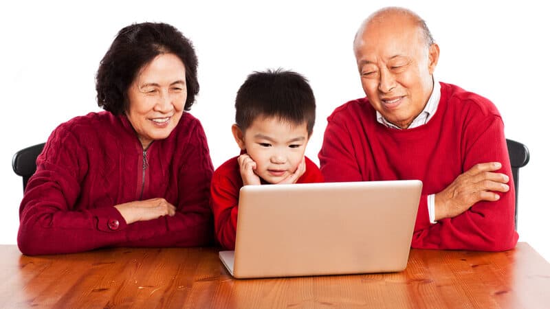 grandparents and grandkid looking at a laptop together, from Suprijono Sujarjoto. Two Jumble puzzles challenge you to pop the secrets. Play one with a favorite kid or use as a warm-up, then tackle the harder puzzle. Image