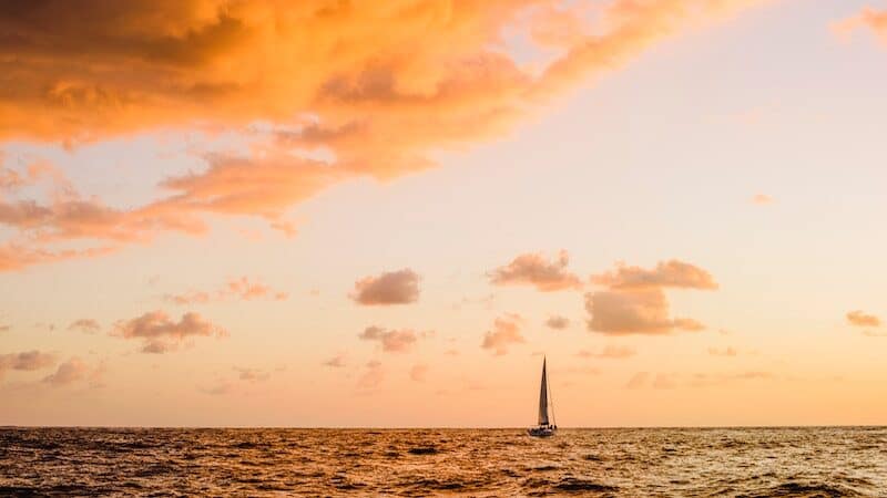 Sailboat on the water at sunset. Take a private sunset cruise to Los Cabos, Mexico, for breathtaking landscapes, turquoise waters, and vibrant sunsets. Image