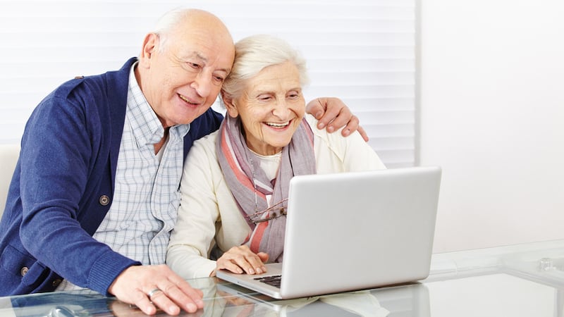 happy senior couple on laptop, from Robert Kneschke. A son wants to keep the family Zoom connection alive for his aging parents, but his siblings have lost interest. See what “Ask Amy” says.